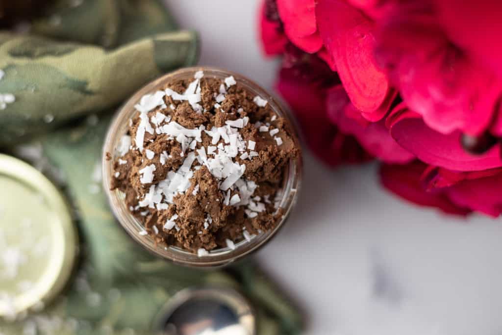 3 ingredient vegan chocolate mousse in a jar with coconut on top.