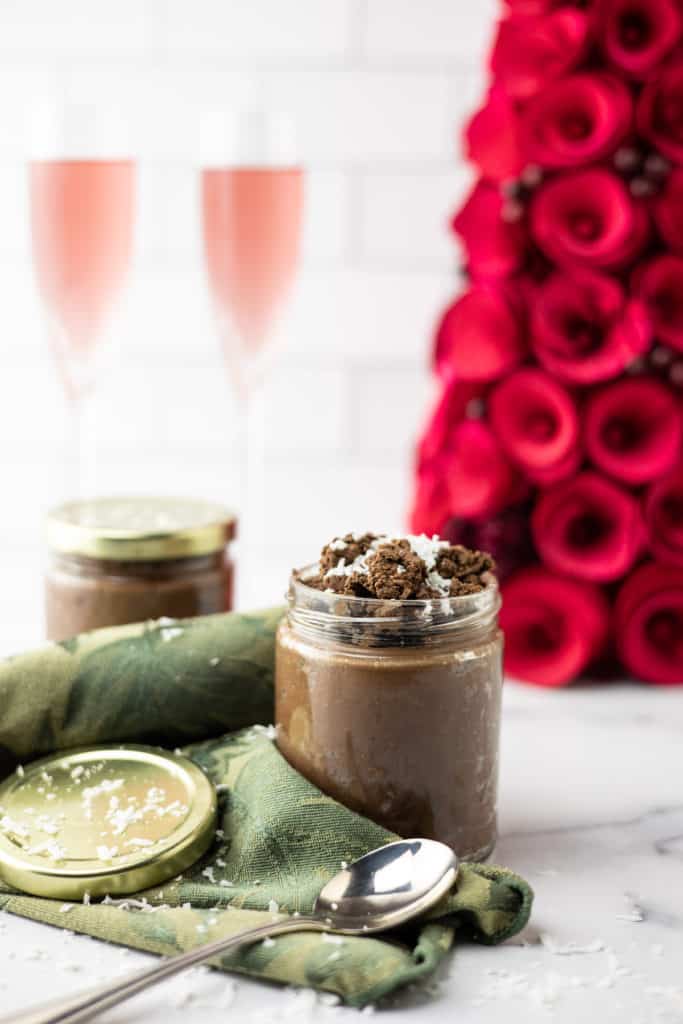 3 ingredient vegan mousse in jars with champagne on a table.